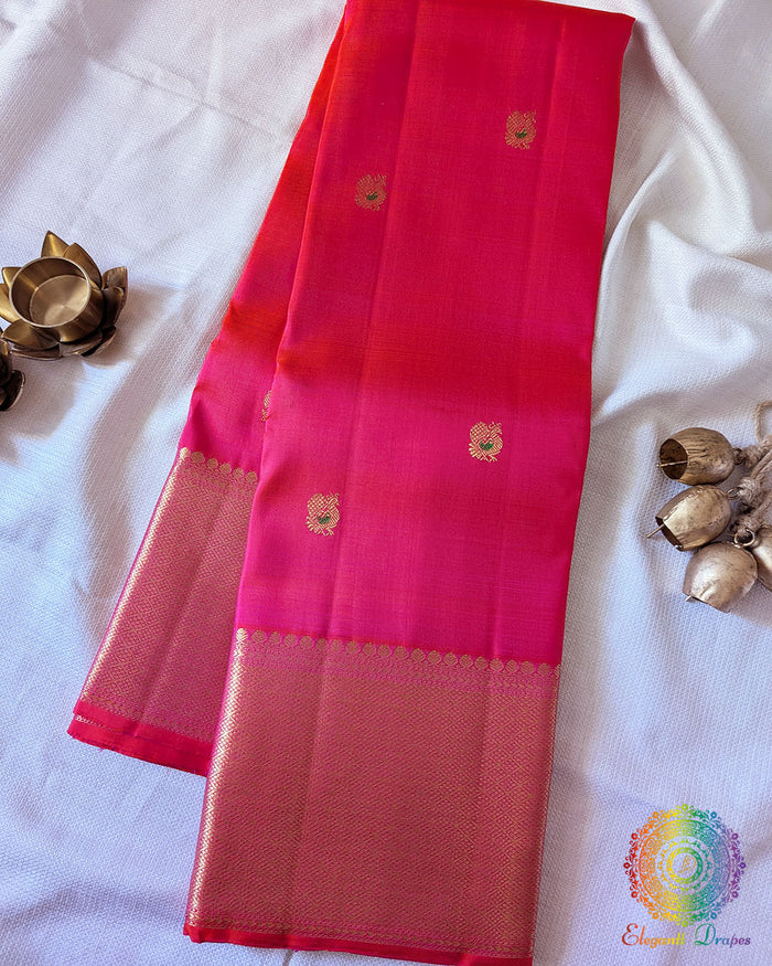 Shot Pink Pure Kanjivaram Handloom Silk Saree with 2gm Gold Zari displayed in a folded view, showcasing the pink-orange shot colour effect and traditional golden zari detailing.