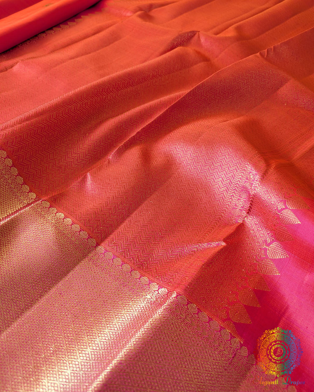 Full view of the Shot Pink Pure Kanjivaram Handloom Silk Saree, displaying its two-tone pink-orange sheen, traditional Kanjivaram weaving and gold zari accents.