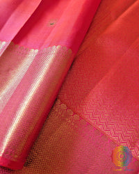 close view of the Shot Pink Pure Kanjivaram Handloom Silk Saree, displaying its two-tone pink-orange sheen, traditional Kanjivaram weaving and gold zari accents.