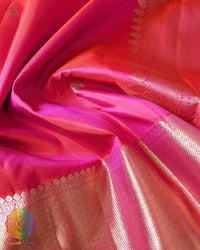 Close-up of the border of the Shot Pink Kanjivaram Silk Saree, highlighting the gold zari weaving against the changing pink and orange silk tones.