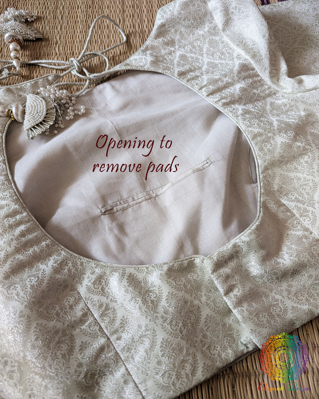 Back opening of the Off White Banarasi Brocade Designer Blouse showing removable pad access