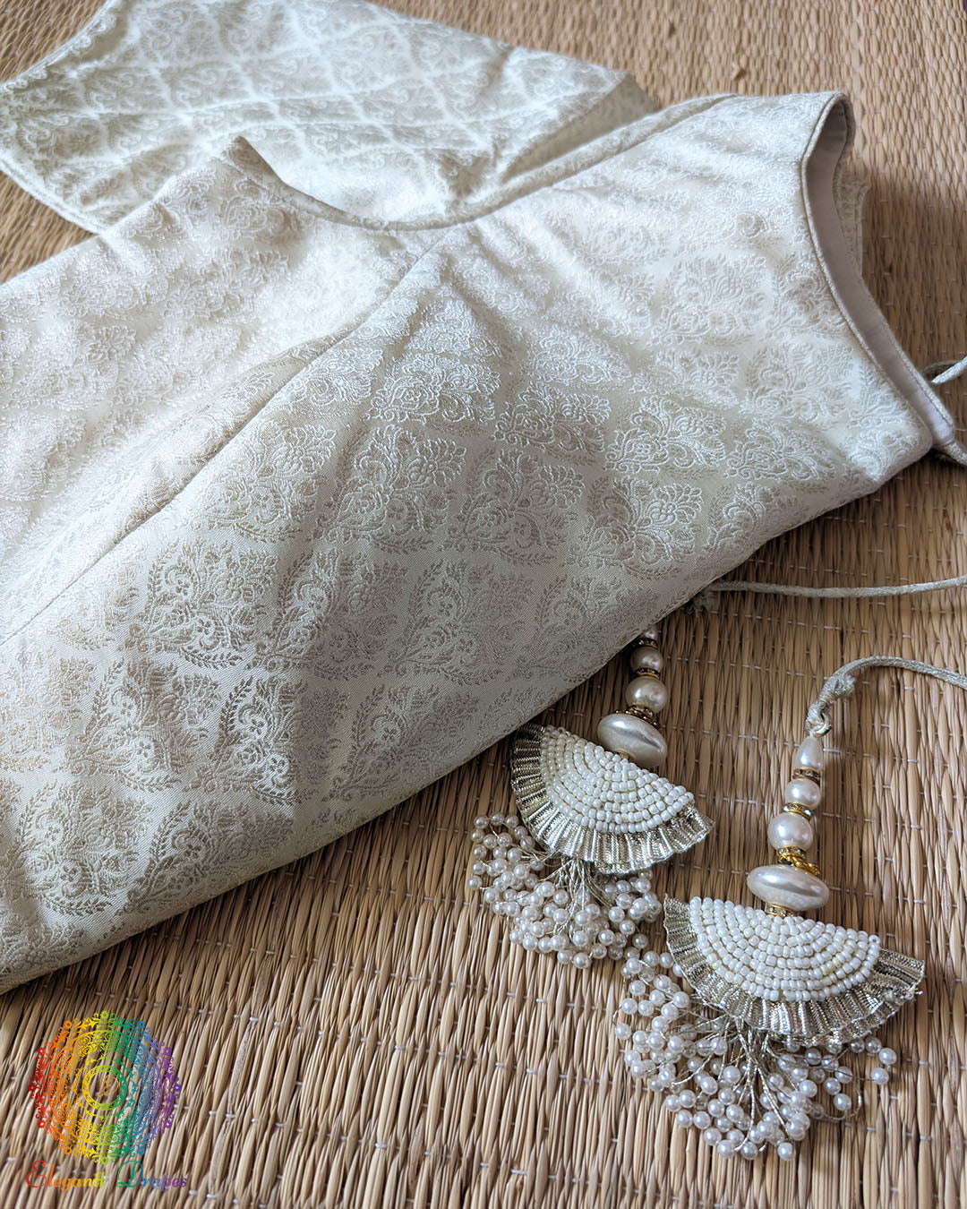 Close-up of the silver zari woven Banarasi brocade paisley pattern on the Off White Designer Blouse