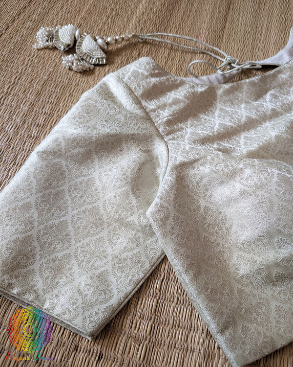 Sleeve detail of the Off White Banarasi Brocade Designer Blouse with silver zari woven paisley motifs