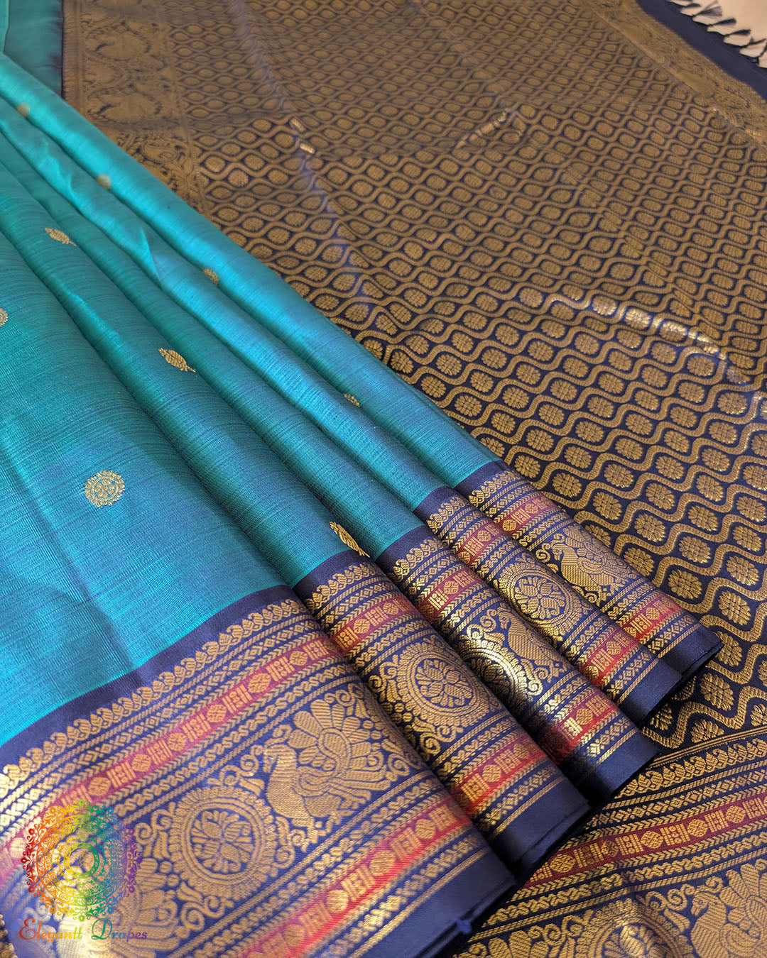 Detailed view of the palla and gold zari design on the Teal Blue Pure Kanjivaram Handloom Silk Saree, showcasing the silk texture and traditional craftsmanship.
