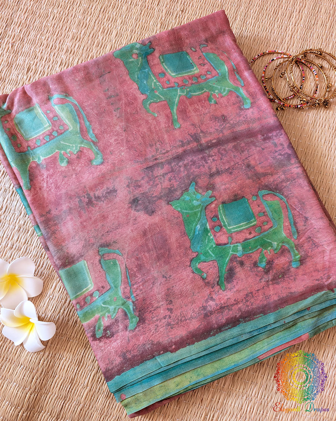 Terracotta Pink Nashpal Pomegranate Ajrakh Modal Tussar Silk Saree folded to display its earthy pink colour, Nashpal Pomegranate Ajrakh print and distinctive striped design.