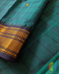 Turquoise Kanchi cotton saree close up highlighting checkered pattern and fabric texture