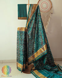 Turquoise handwoven mulberry silk Rajkot Patola saree on mannequin showing full drape