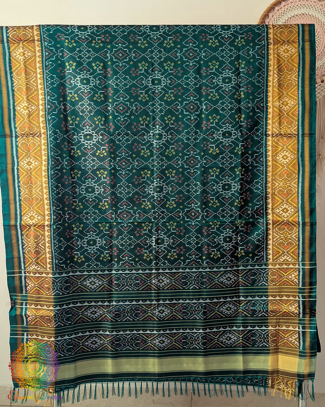 Open palla view of turquoise Rajkot Patola pure mulberry silk saree displaying woven design