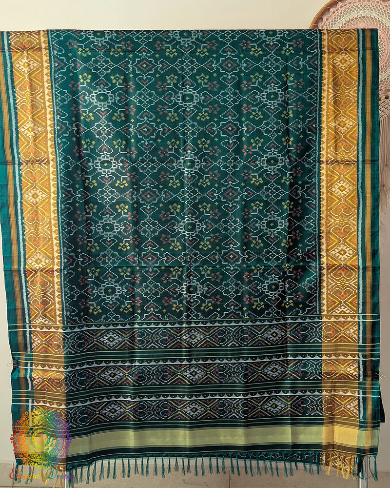 Open palla view of turquoise Rajkot Patola pure mulberry silk saree displaying woven design