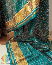 Turquoise Rajkot Patola saree palla close up highlighting intricate woven motifs