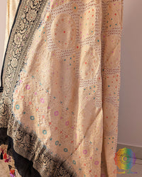 Close up of white black bandhani dupatta showing tie dye and meenakari weaving