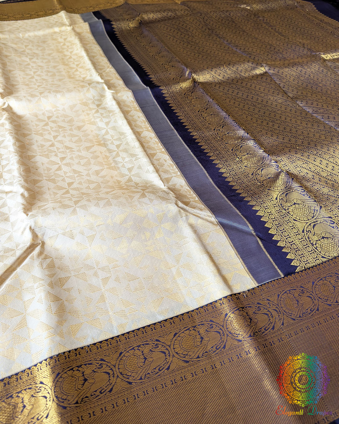 Off white Kanjivaram silk saree body close up highlighting all-over golden zari weaving