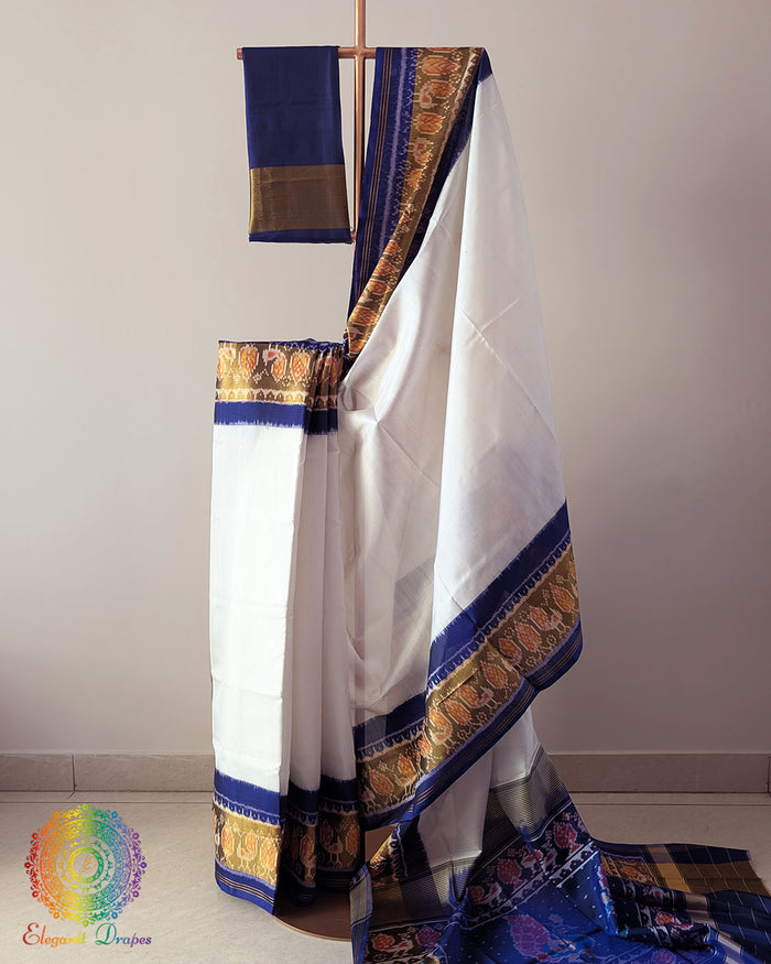 White Blue Handwoven Mulberry Silk Rajkot Patola Saree – Full Drape View showcasing the elegant white and blue colour combination, intricate traditional Patola motifs and graceful drape of the handwoven mulberry silk saree.