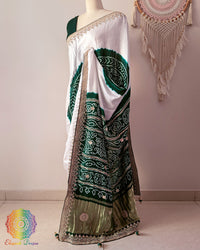 Side angle view of white and green gaji silk Rasmandal saree showcasing elegant silk drape
