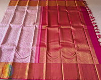 Full white pink Kanjivaram saree laid open showing woven body design and pink border