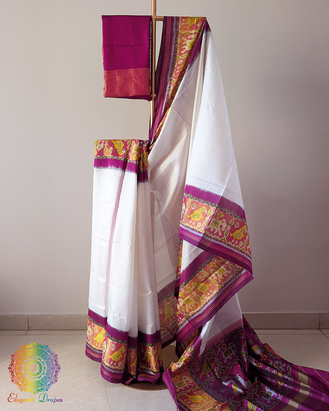White Pink Handwoven Mulberry Silk Rajkot Patola Saree – Full Drape View showcasing the elegant white and pink colour combination, traditional Rajkot Patola motifs and the rich texture of handwoven mulberry silk in a graceful drape.