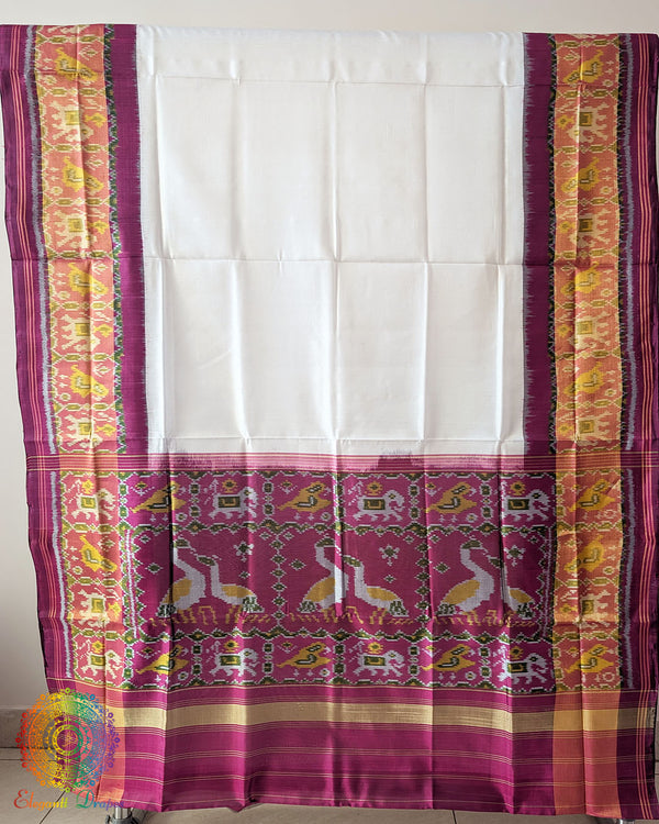 White Pink Handwoven Mulberry Silk Rajkot Patola Saree – Full Saree View displaying the complete saree with its intricate traditional patterns, contrasting pink details and white silk base, highlighting the artistry of Gujarati Patola weaving.