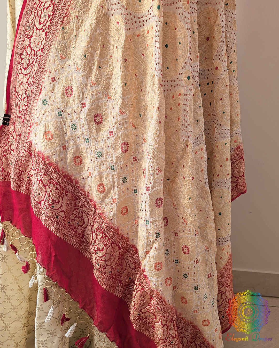 Close up of white red bandhej dupatta showing bareek bandhani and meenakari work