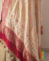 Close up of white red bandhej dupatta showing bareek bandhani and meenakari work