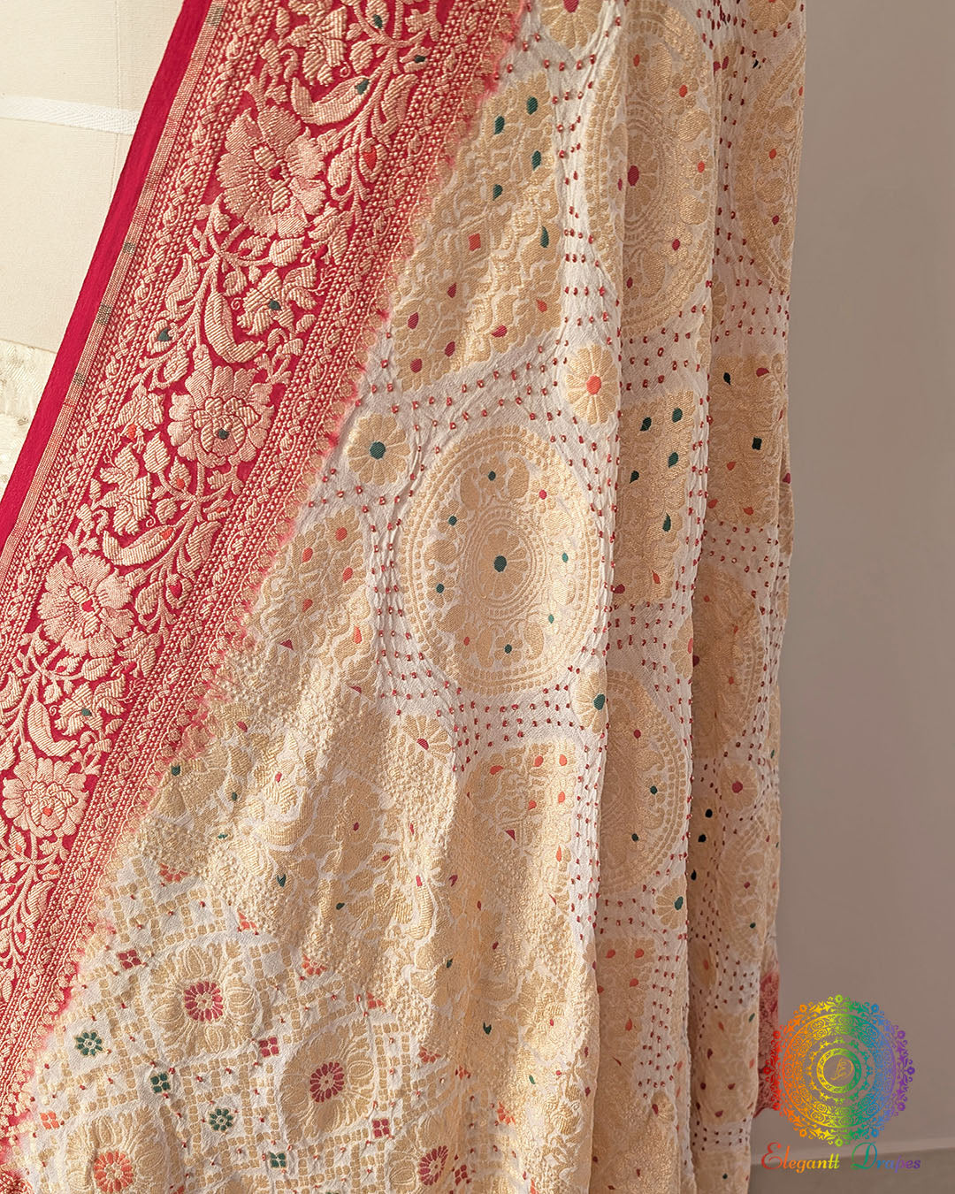 Close up of white red rai bandhej dupatta showing bareek bandhani and meenakari work