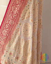 Close up of white red rai bandhej dupatta showing bareek bandhani and meenakari work