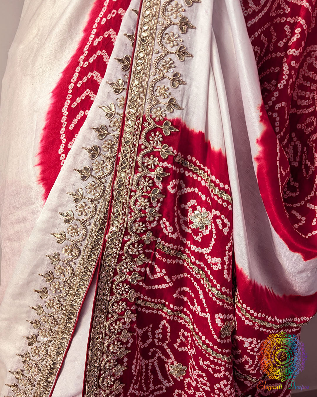 Close up of gota patti border work and red Rasmandal motifs on gaji silk saree