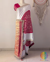 White and red gaji silk Rasmandal saree on mannequin showing full drape and gota patti border work