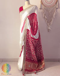 Side angle view of white and red gaji silk Rasmandal saree showcasing elegant silk drape