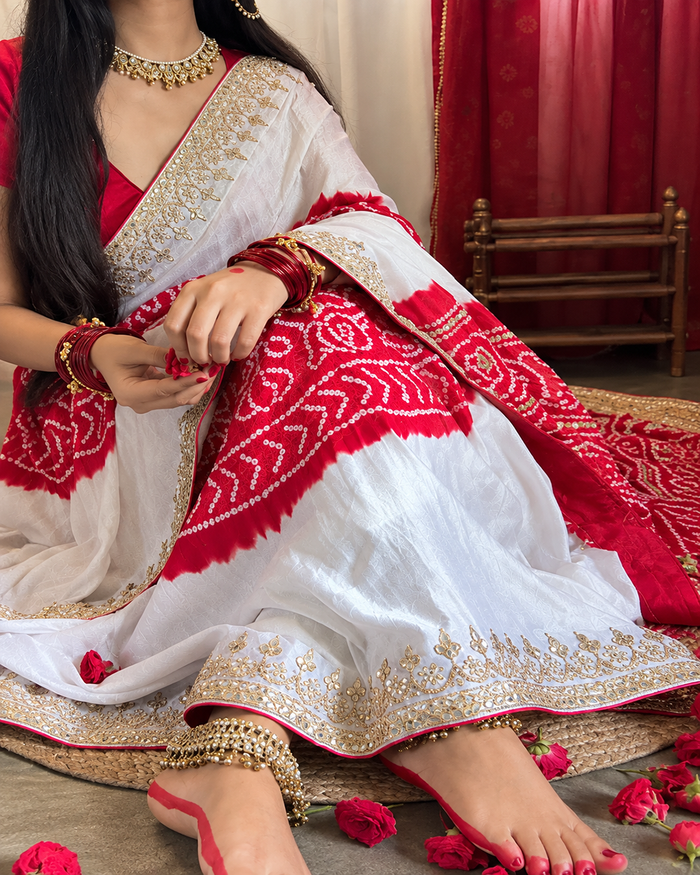 Model wearing our white and red gaji silk Rasmandal saree with gota patti handwork