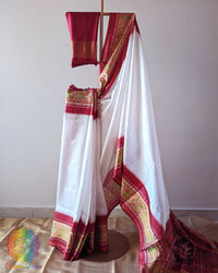 White Red Handwoven Mulberry Silk Rajkot Patola Saree – Full Drape View showcasing the elegant plain white body paired with a striking red palla and border, highlighting the beautiful contrast and traditional Gujarati textile appeal.
