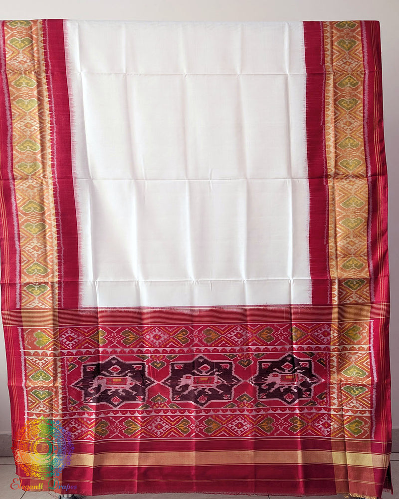 White Red Handwoven Mulberry Silk Rajkot Patola Saree – Full Saree View displaying the complete saree with its pristine white body, rich red palla and coordinated red border, showcasing the natural sheen and graceful drape of mulberry silk.