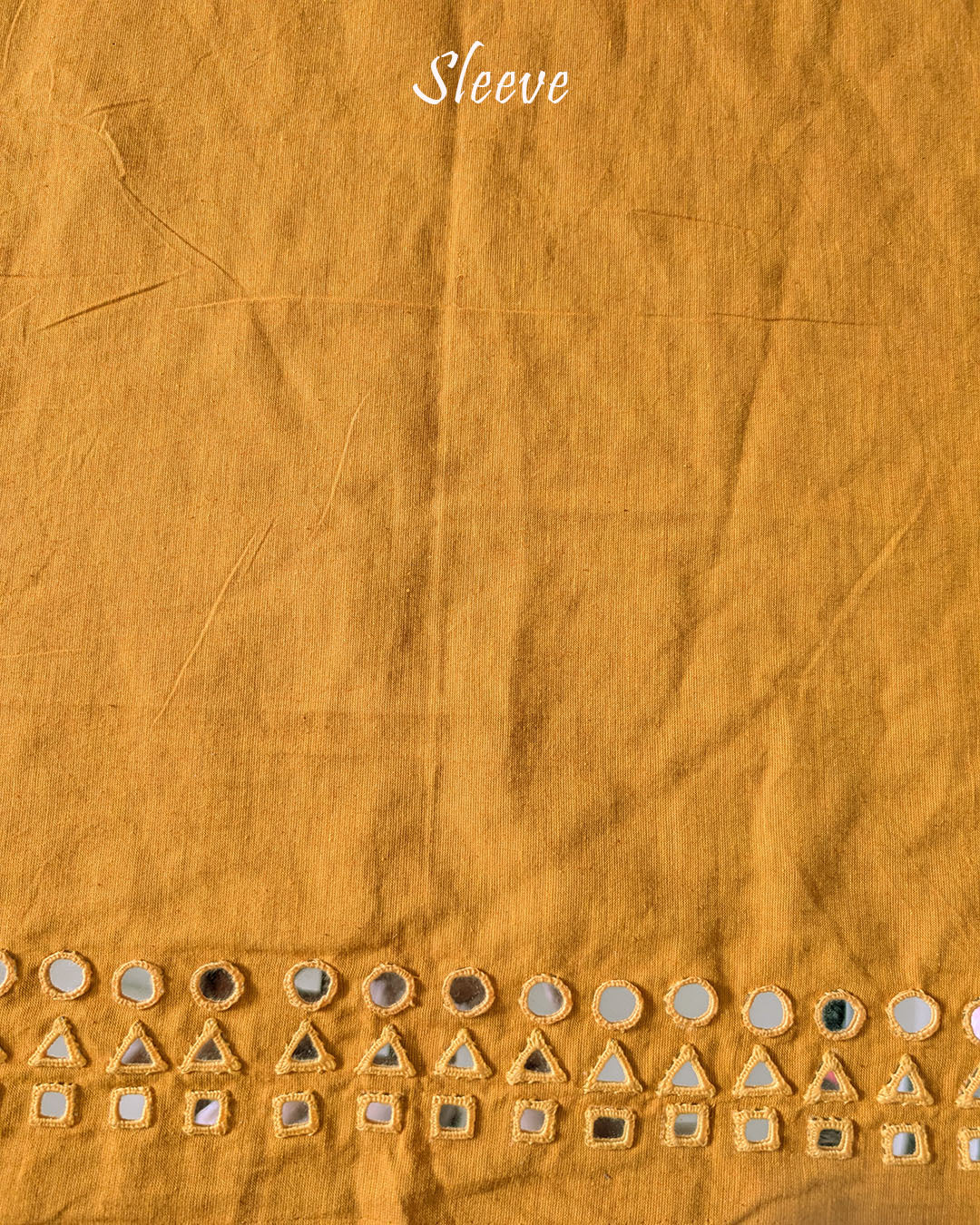 Sleeve detail of the Mustard Yellow Kala Cotton Kutch Mirror Handwork blouse piece, highlighting the real mirror embellishments, decorative threadwork and warm mustard yellow fabric.