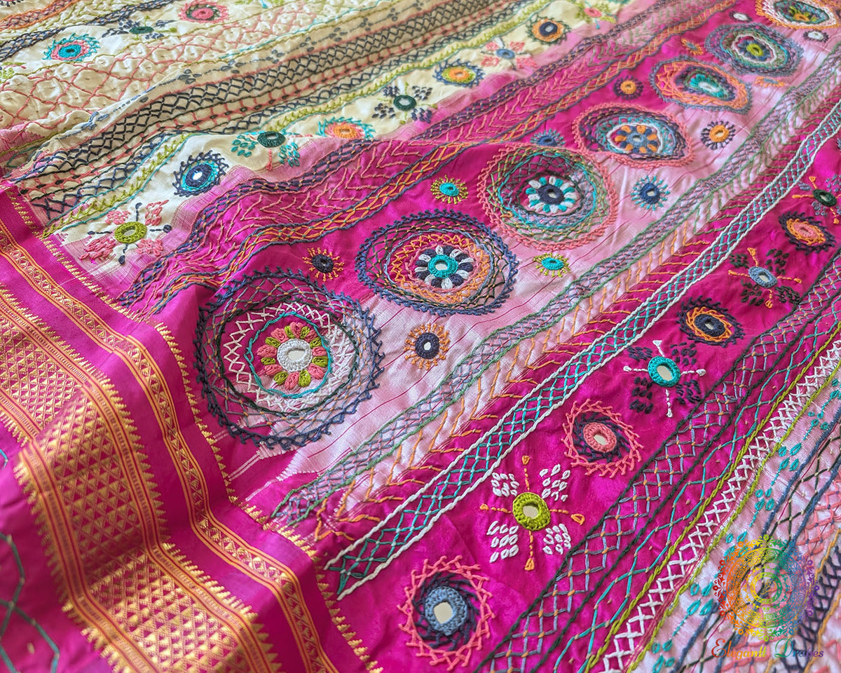 Detailed view of pink palla with intricate Lambani embroidery on silk saree