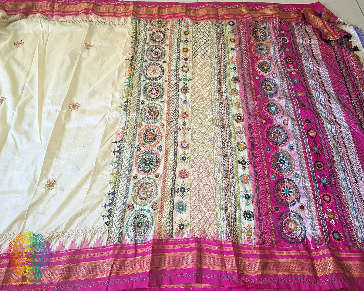 Full pale yellow Ilkal silk saree laid flat showing pink palla and border