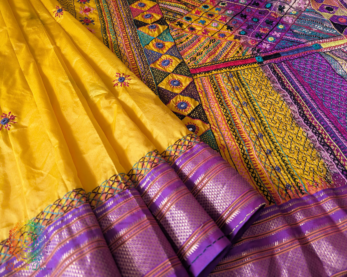 Purple border close up on yellow Ilkal silk saree highlighting embroidery