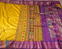 Traditional embroidered motif detail on yellow Ilkal silk saree