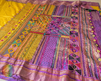 Intricate Lambani hand embroidery detail on yellow silk saree