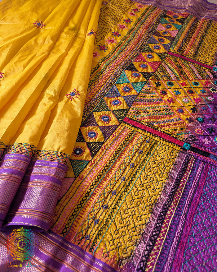 Yellow pure Ilkal silk saree laid open showing purple palla and border