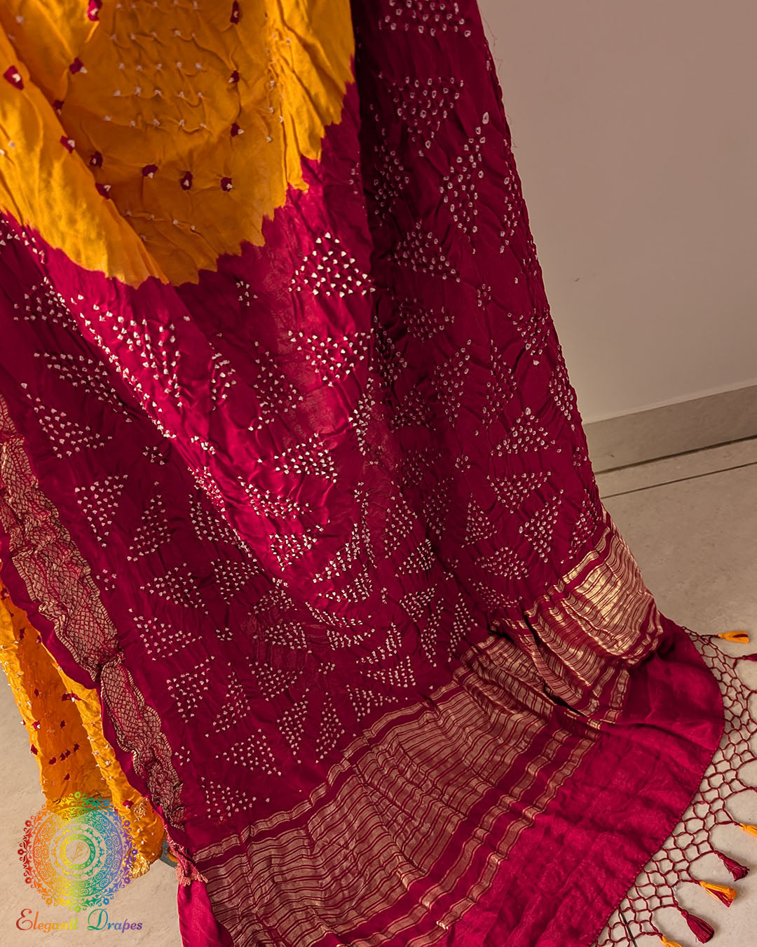 Close up of traditional Bandhani motifs on mustard yellow pure gaji silk saree