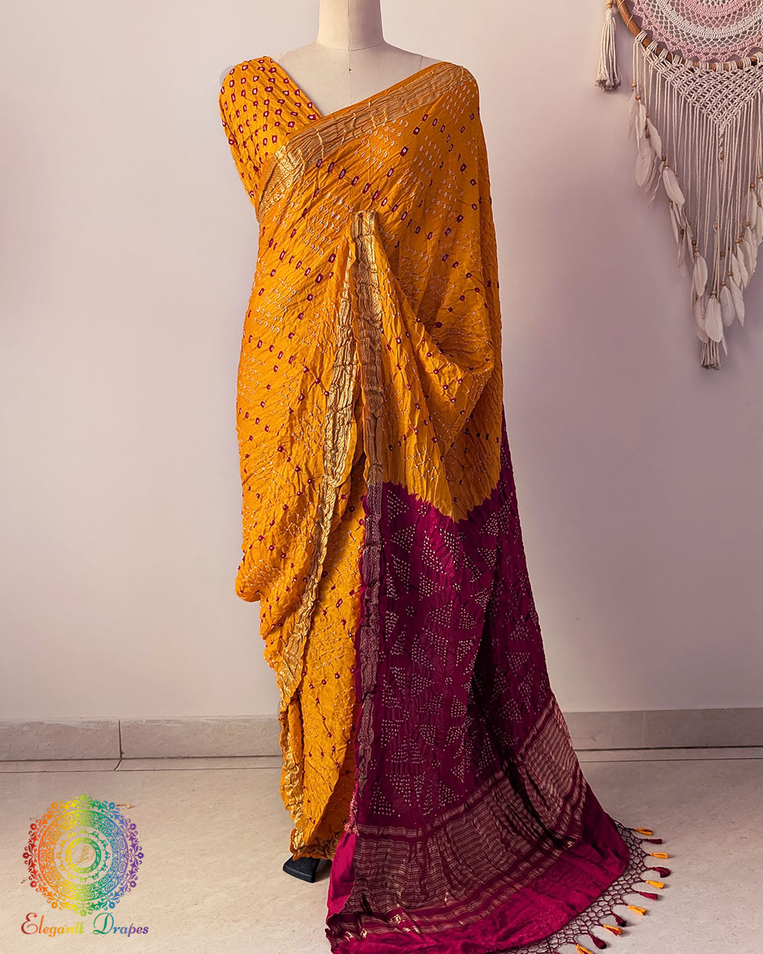 Mustard yellow pure gaji silk Bandhani saree on mannequin with red palla and Nakshi woven border