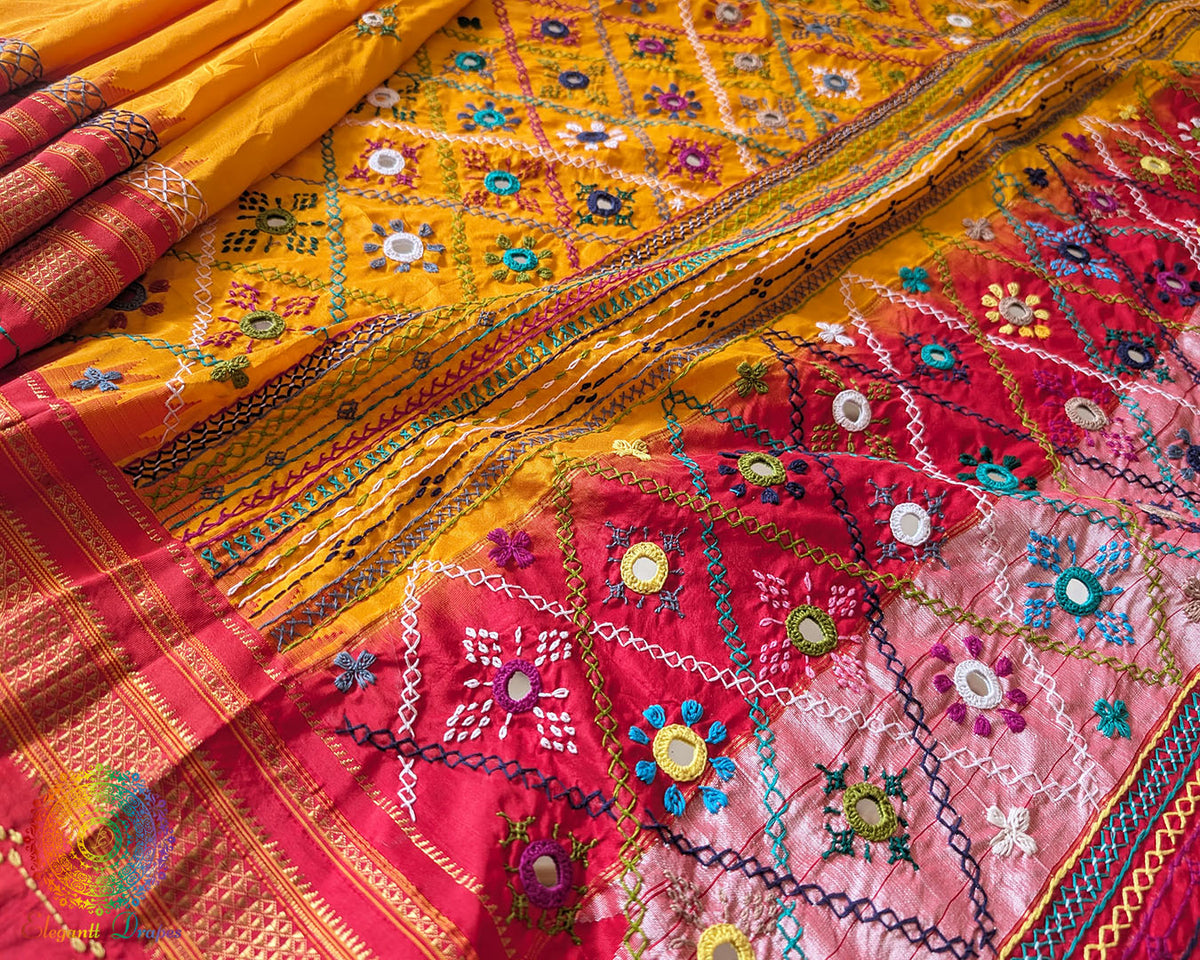 Red palla close up on yellow Ilkal silk saree highlighting Lambani embroidery