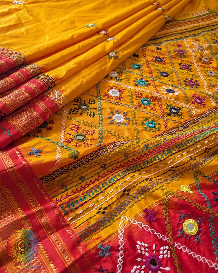 Yellow red pure Ilkal silk saree laid open showing red palla and border