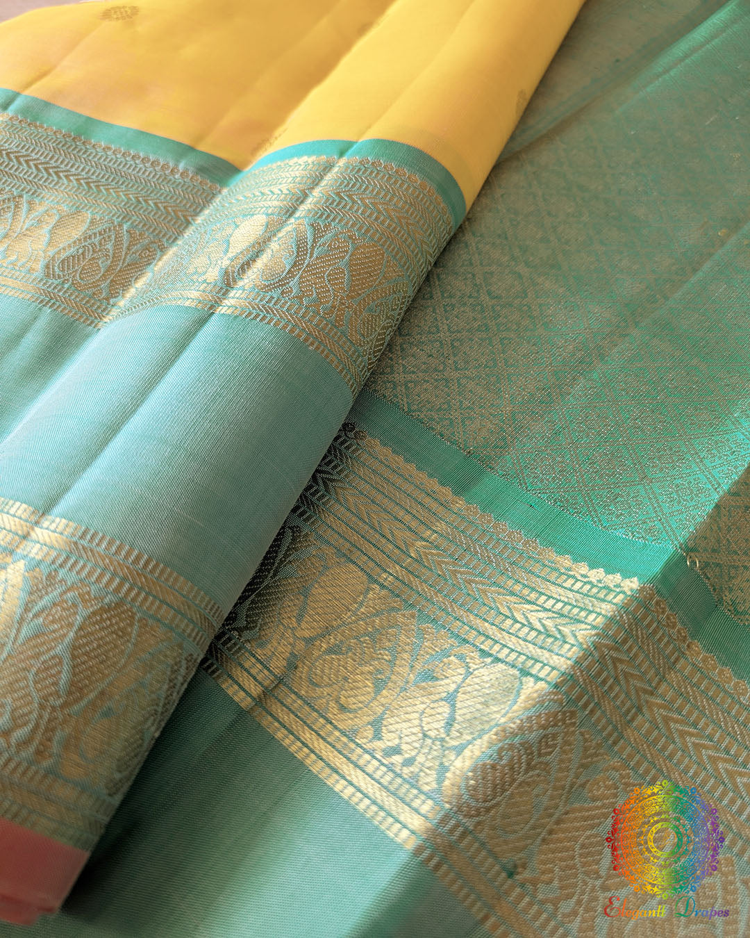 Yellow Pure Kanjivaram Silk Saree – Sea Green Zari Border Close-Up showcasing the traditional woven detailing along the sea green border and its contrast with the pale yellow silk body.