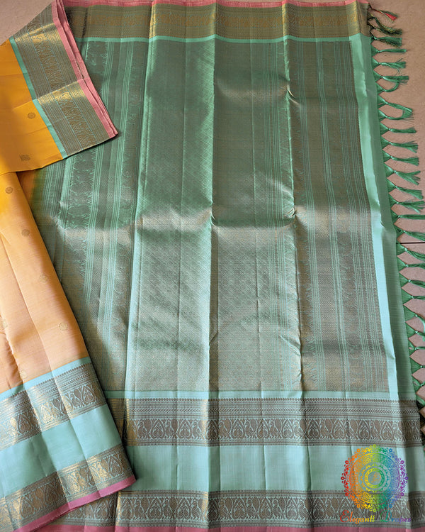 Yellow Pure Kanjivaram Silk Saree – Open Full View displaying the complete saree with its pale yellow body adorned with gold zari bootas and a contrasting sea green palla and border.