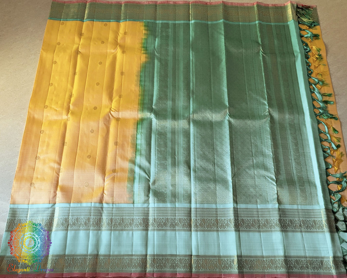 Pale Yellow Kanjivaram Handloom Silk Saree – Full Length View highlighting the elegant yellow body, evenly woven zari bootas and rich sea green border that adds a traditional touch to the saree