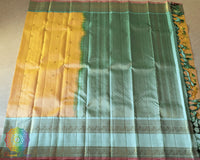 Pale Yellow Kanjivaram Handloom Silk Saree – Full Length View highlighting the elegant yellow body, evenly woven zari bootas and rich sea green border that adds a traditional touch to the saree