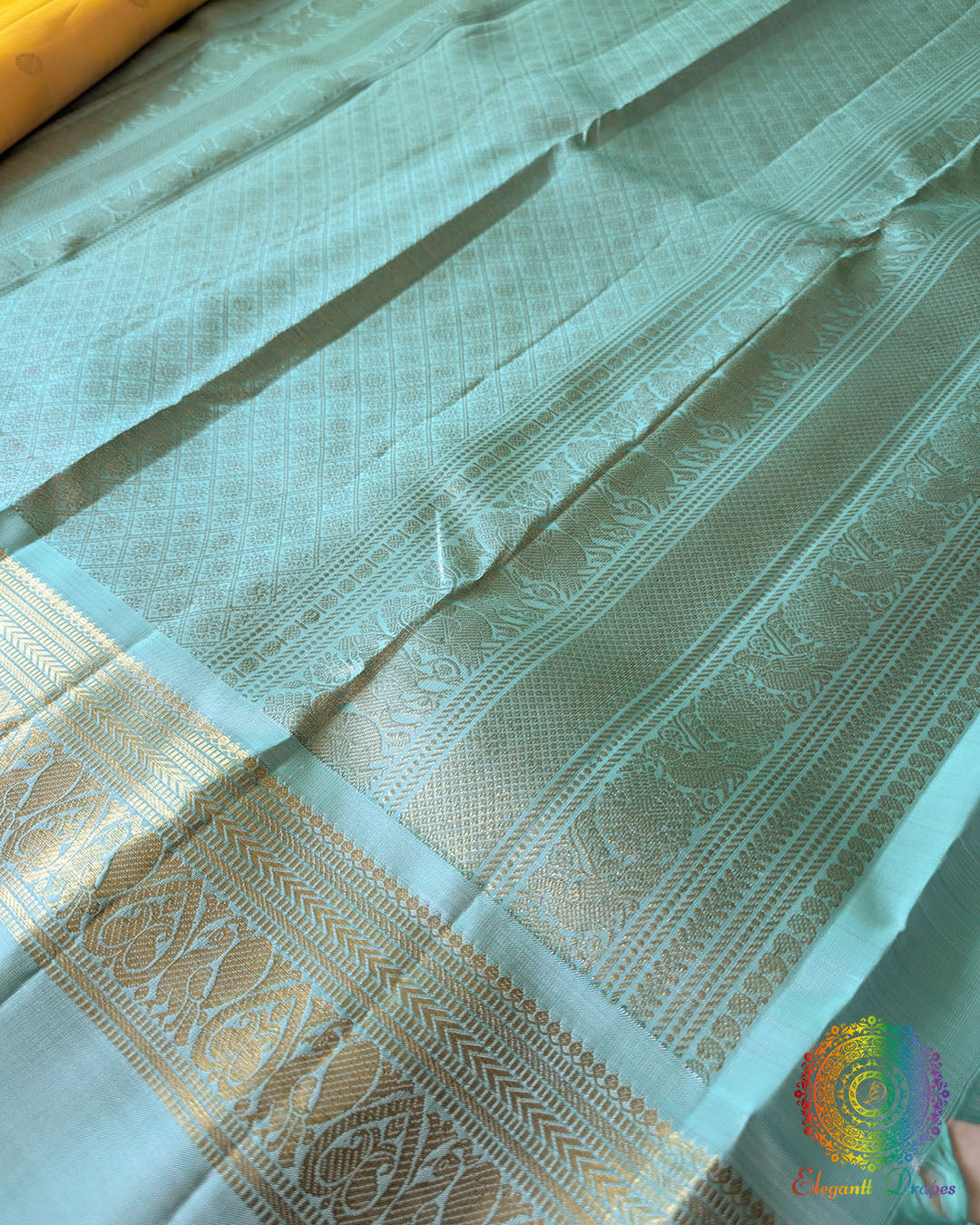 Yellow Pure Kanjivaram Silk Saree – Sea Green Palla Close-Up showcasing the contrasting sea green palla with its traditional woven details and elegant finish against the pale yellow body.